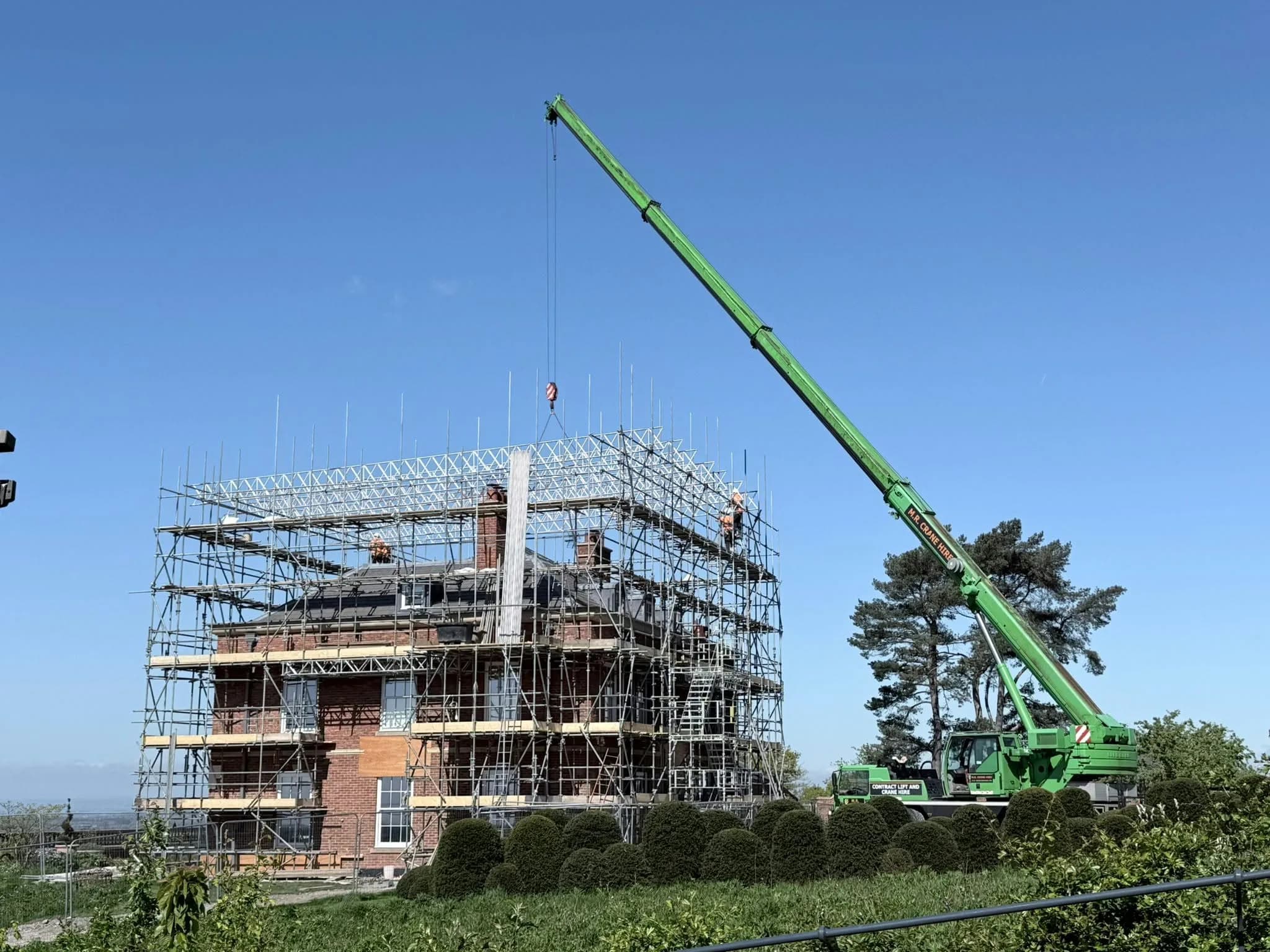 M.R. Crane Hire mobile crane lifting steelwork on a construction site